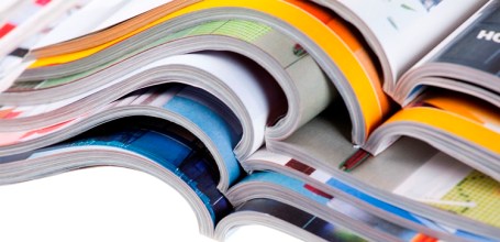 Pile of colour illustrated magazines on white background. Isolated.